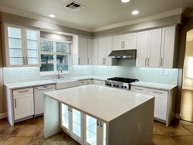 a kitchen with a stove a sink and a microwave