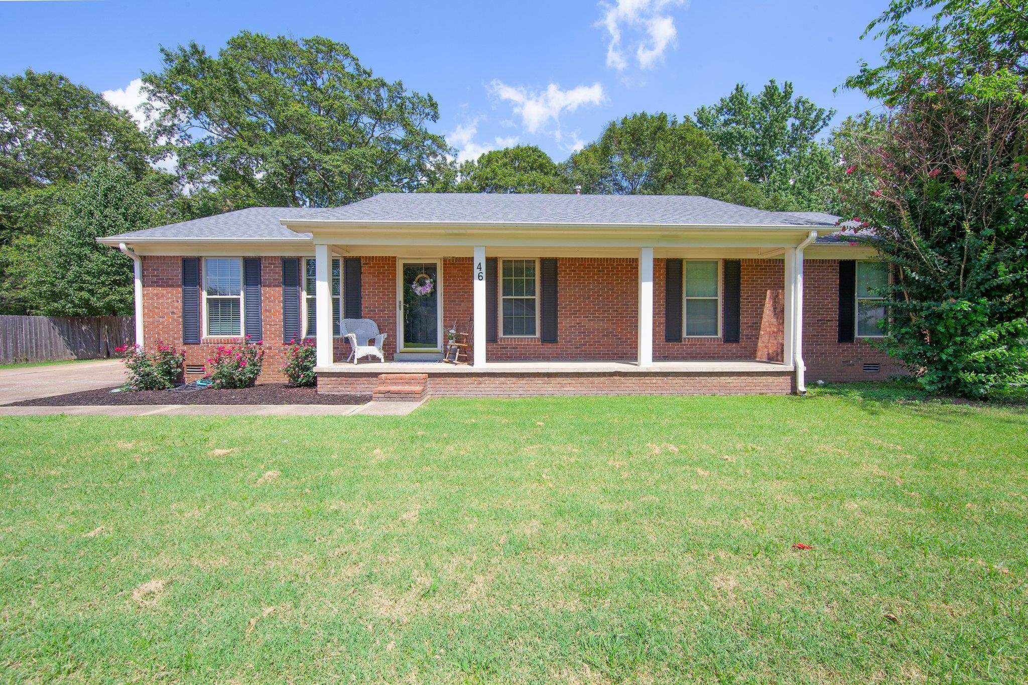 a view of a house with a backyard and patio