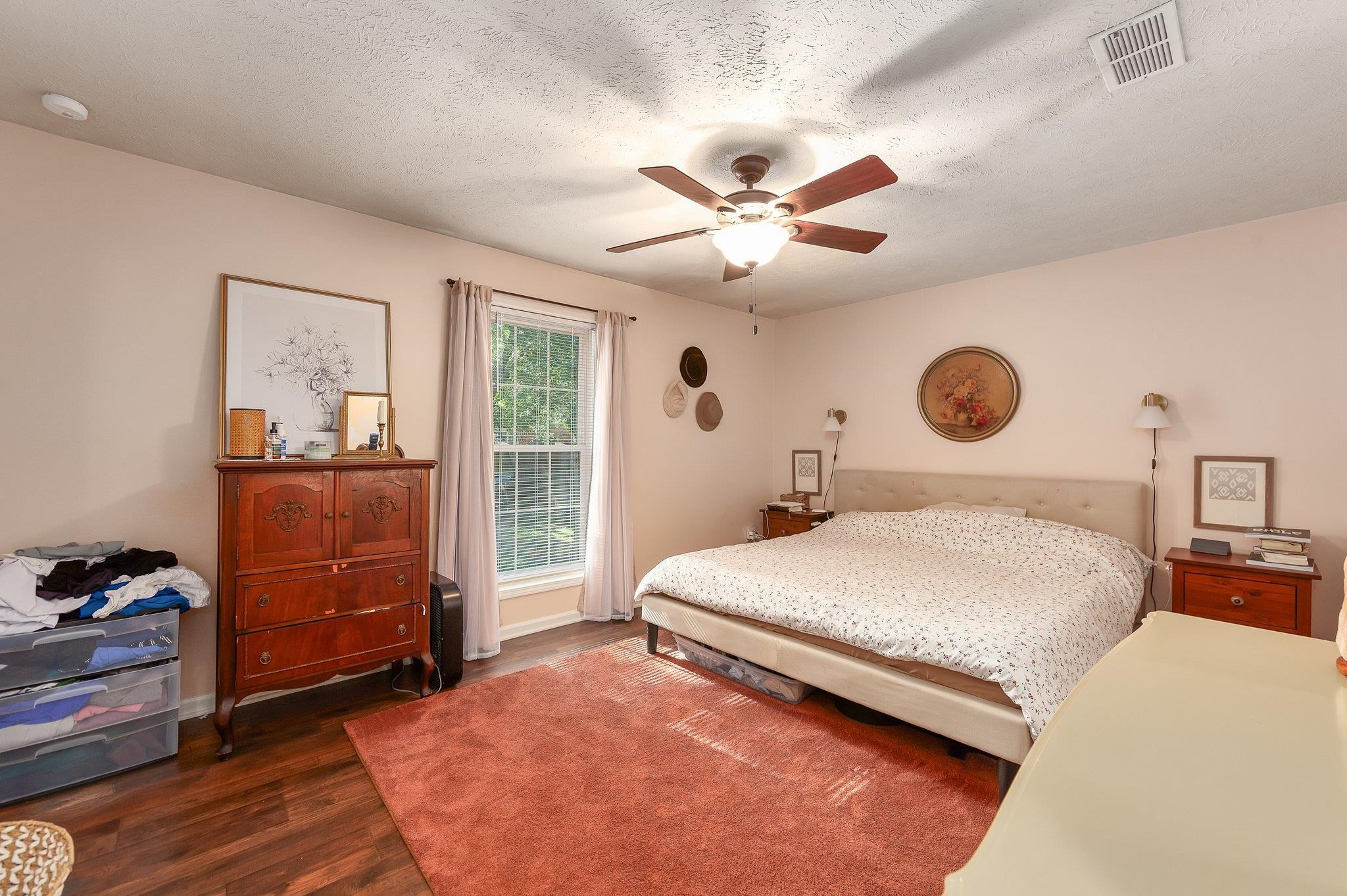 46 Commanche Cove Jackson, TN 38305 - Photo 22 of 29 a bedroom with a large bed and a chandelier