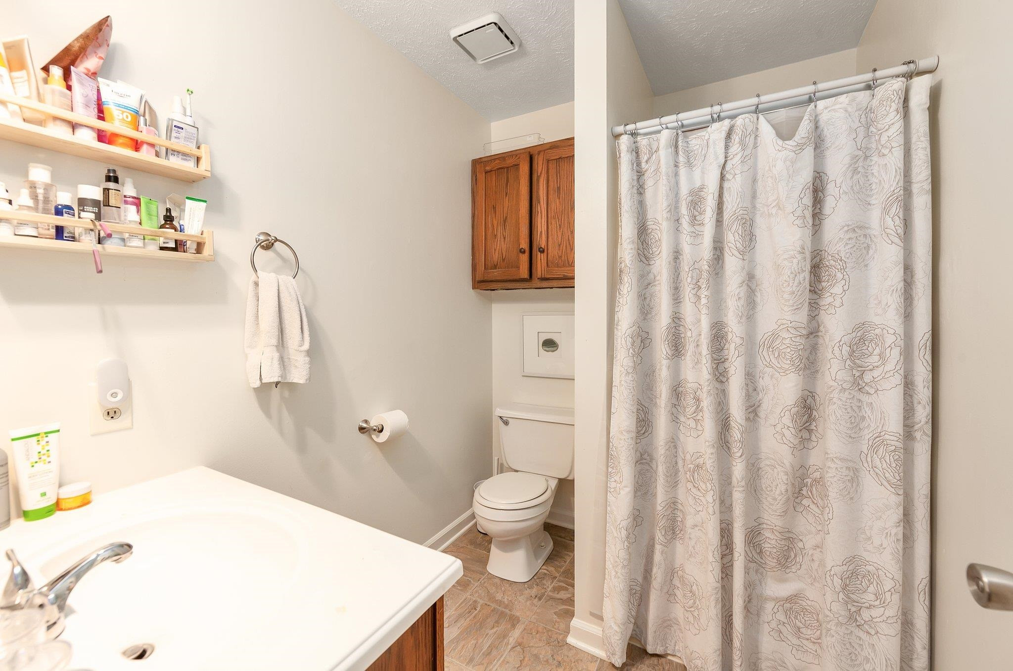 46 Commanche Cove Jackson, TN 38305 - Photo 24 of 29 a bathroom with a sink a toilet and shower curtain