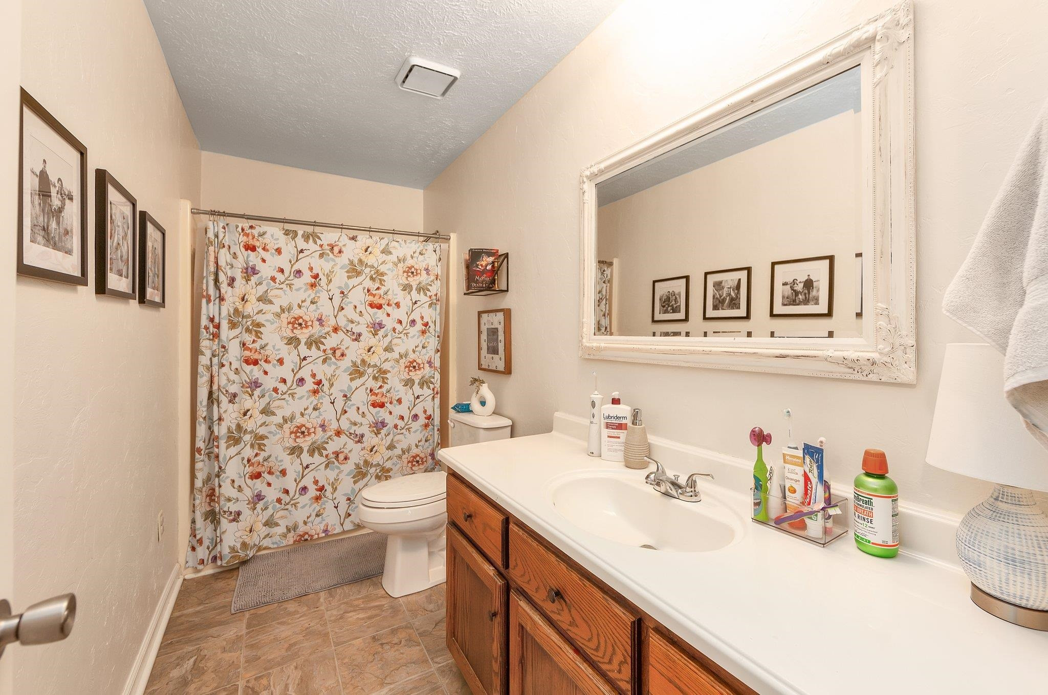 46 Commanche Cove Jackson, TN 38305 - Photo 26 of 29 a bathroom with a sink a toilet and a shower curtain
