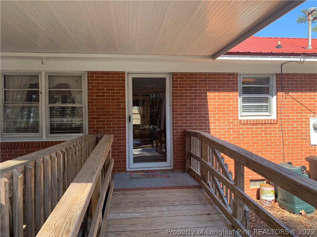 7114 Clinton Road Stedman, NC 28391 - Photo 3 of 34 a view of a balcony with wooden floor and stairs