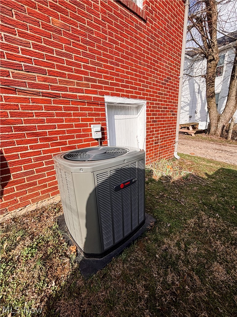 724 East Main Street Barnesville, OH 43713 - Photo 27 of 28 Exterior view of brick siding and a central AC unit