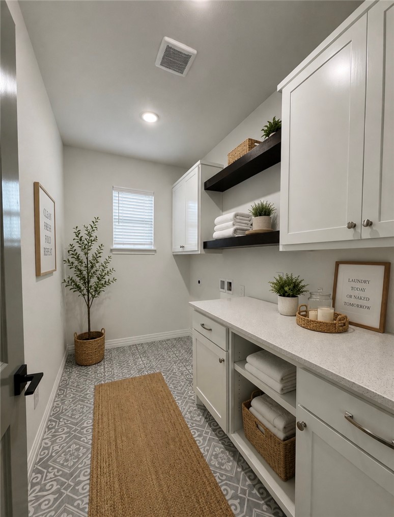 3245 Hunters Crossing Bryan, TX 77808 - Photo 19 of 30 Laundry area featuring patterned tile flooring, white shaker-style cabinetry, a light-colored countertop, and recessed ceiling lighting