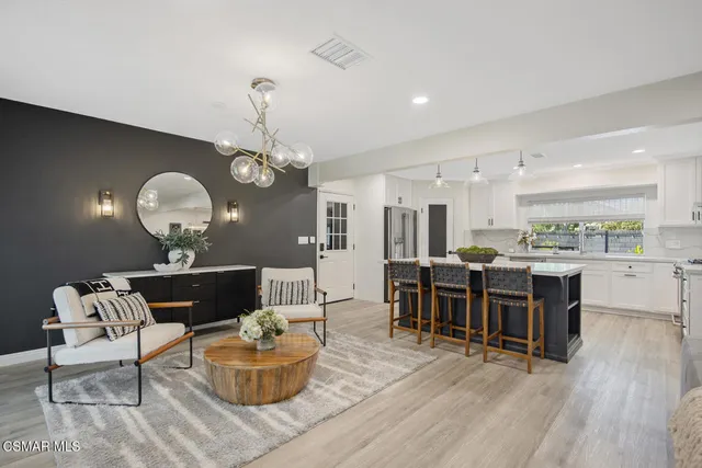 a living room with furniture and kitchen view
