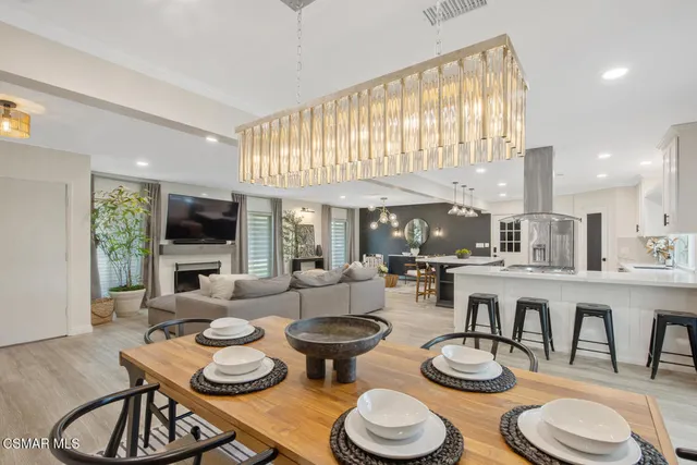 a dining room with furniture a rug and a large window