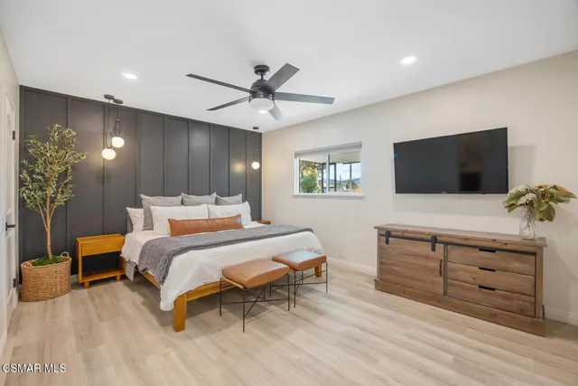 a bedroom with a bed and a flat screen tv