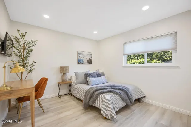 a bedroom with a bed and a chair