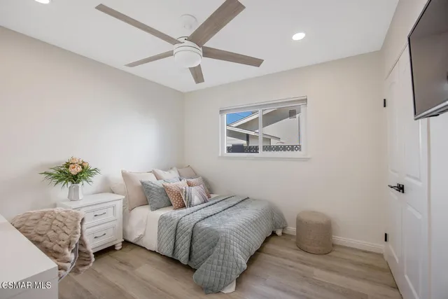 a bedroom with a bed and a couch