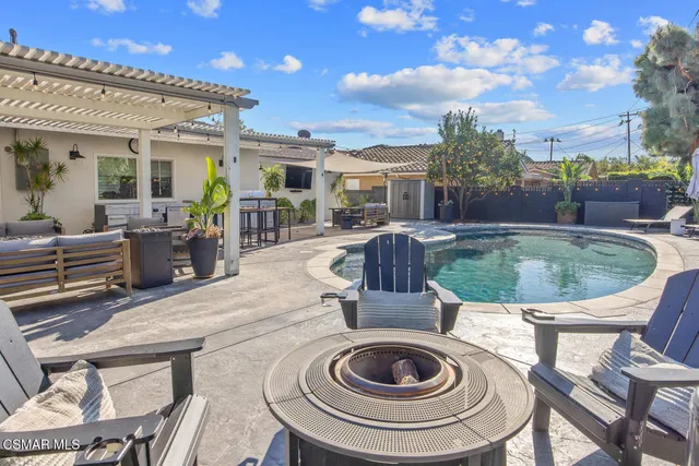 a view of a house with swimming pool and porch with furniture