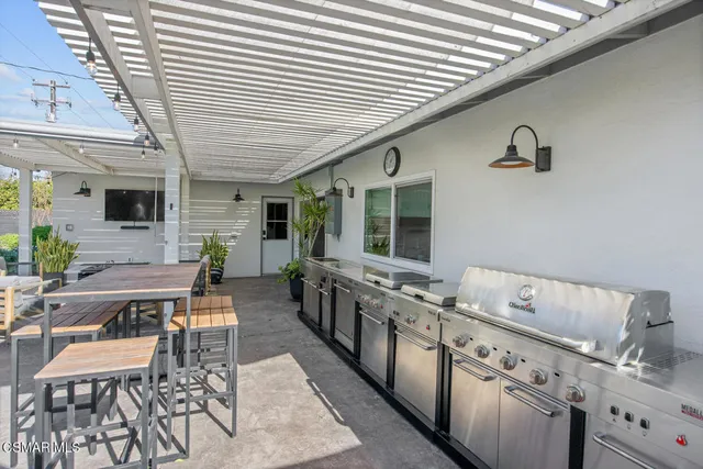 a kitchen with cabinets table and chairs