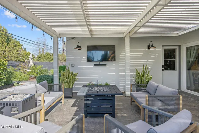 a view of a patio with couches chairs and a potted plant