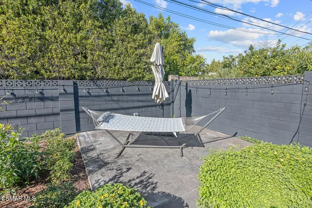 a view of a backyard with chairs