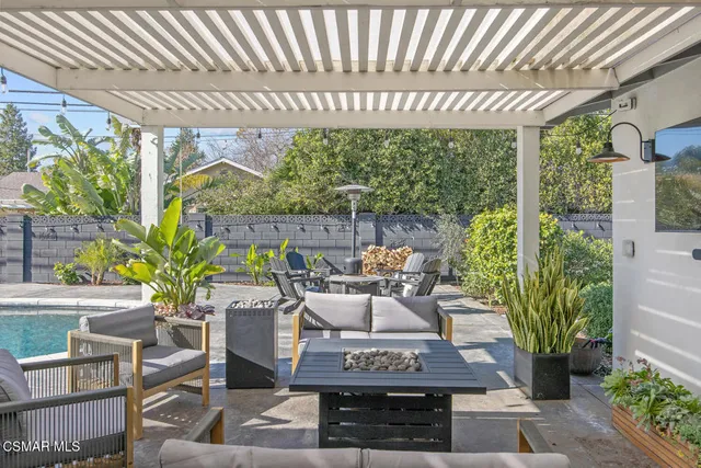 a view of a patio with table and chairs potted plants with wooden floor
