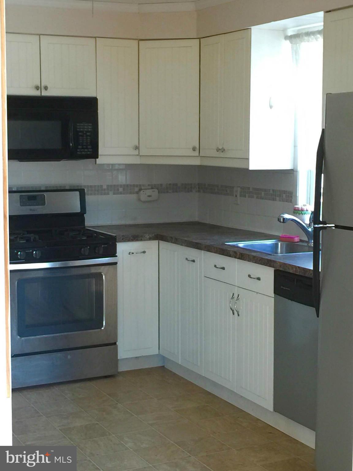 8 Ridgemoor Road Baltimore, MD 21221 - Photo 5 of 13 a kitchen with granite countertop white cabinets and stainless steel appliances