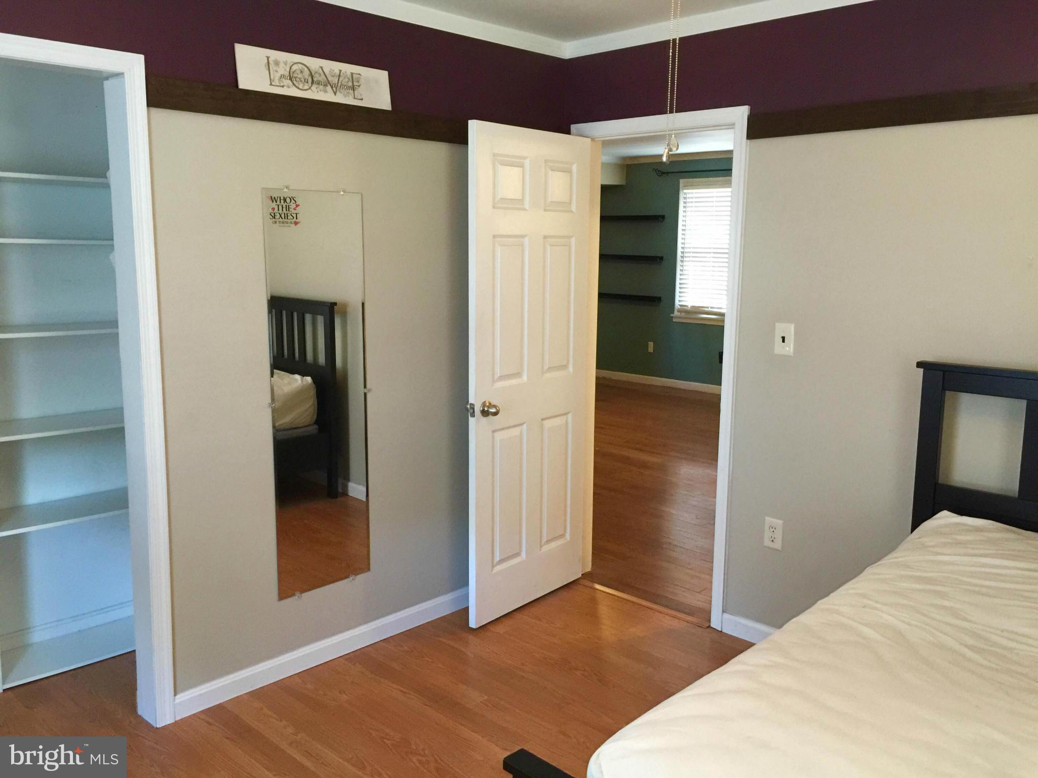 8 Ridgemoor Road Baltimore, MD 21221 - Photo 6 of 13 a bedroom with a bed and a glass door