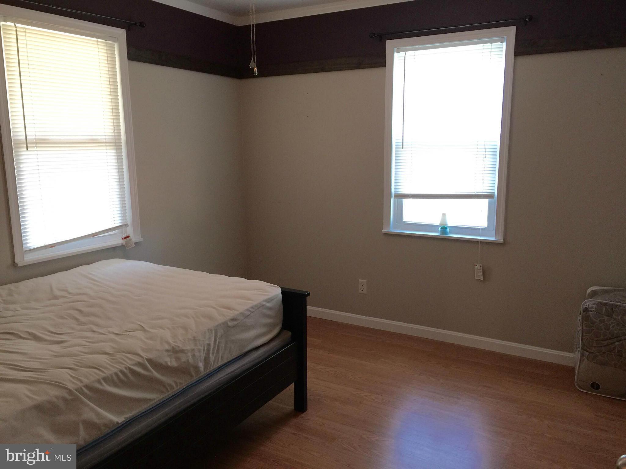 8 Ridgemoor Road Baltimore, MD 21221 - Photo 7 of 13 a bed sitting in a bedroom next to a window