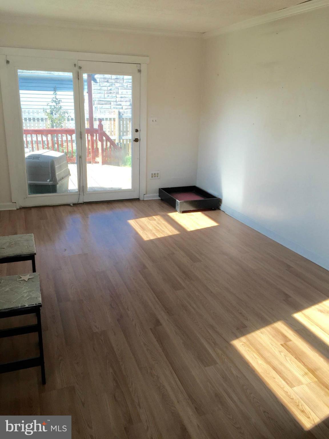 8 Ridgemoor Road Baltimore, MD 21221 - Photo 9 of 13 a view of empty room with wooden floor and fan