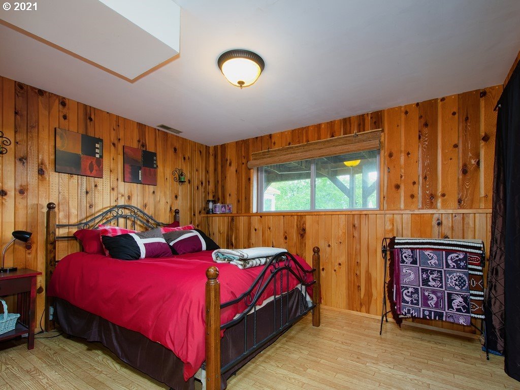 8025 Greentree Ridge Road Tillamook, OR 97141 - Photo 22 of 32 a bedroom with a large bed and a window
