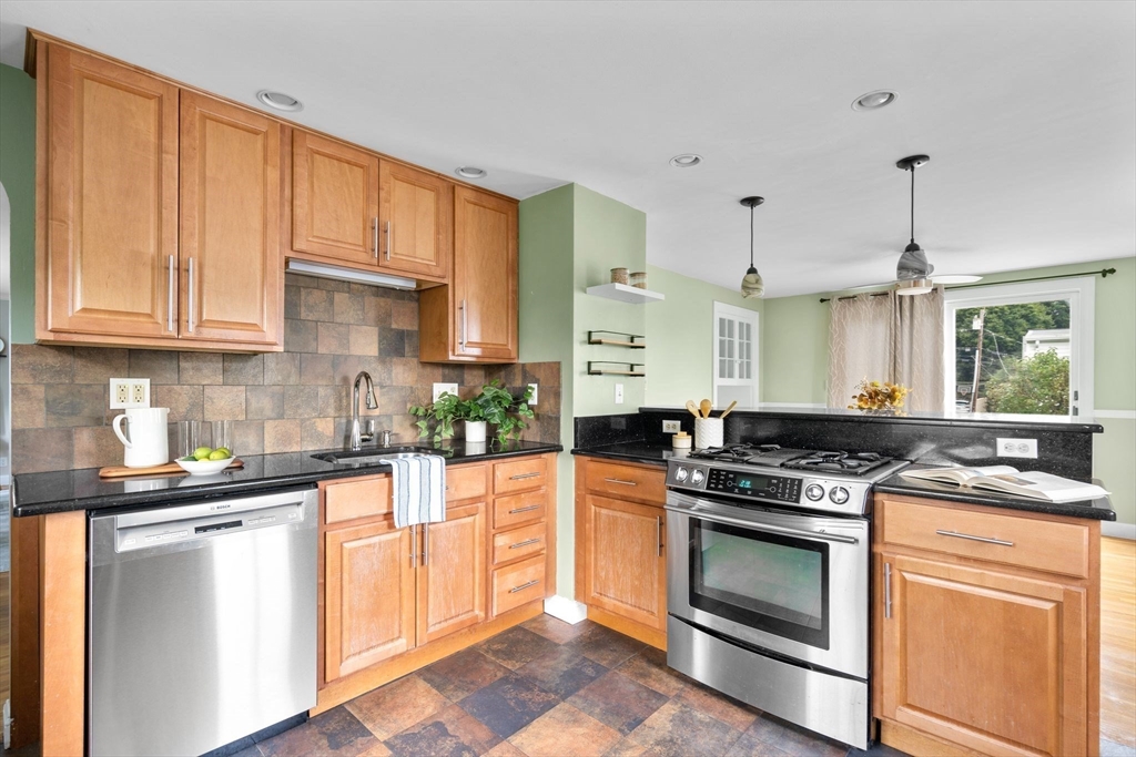 29 Walnut Terrace Arlington, MA 02476 - Photo 15 of 41 a kitchen with stainless steel appliances granite countertop a stove a sink and a refrigerator