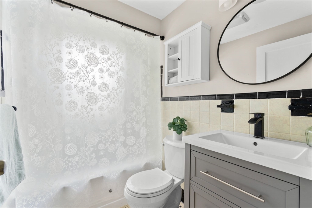 29 Walnut Terrace Arlington, MA 02476 - Photo 30 of 41 a bathroom with a sink a mirror a toilet and a mirror