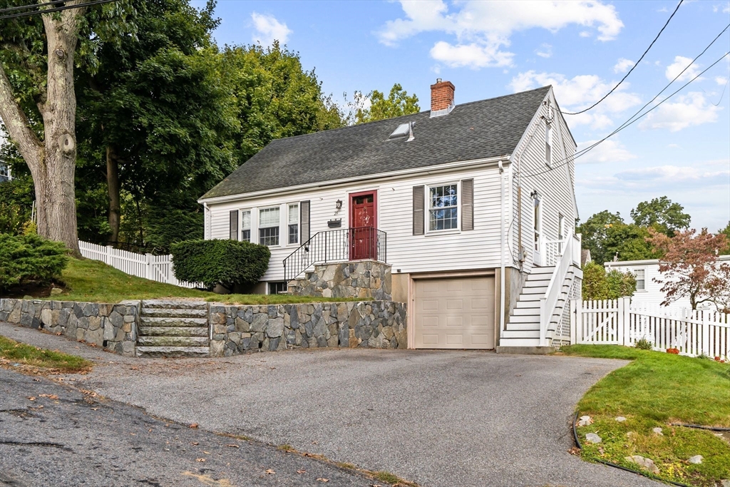 29 Walnut Terrace Arlington, MA 02476 - Photo 41 of 41 a front view of a house with a yard and garage