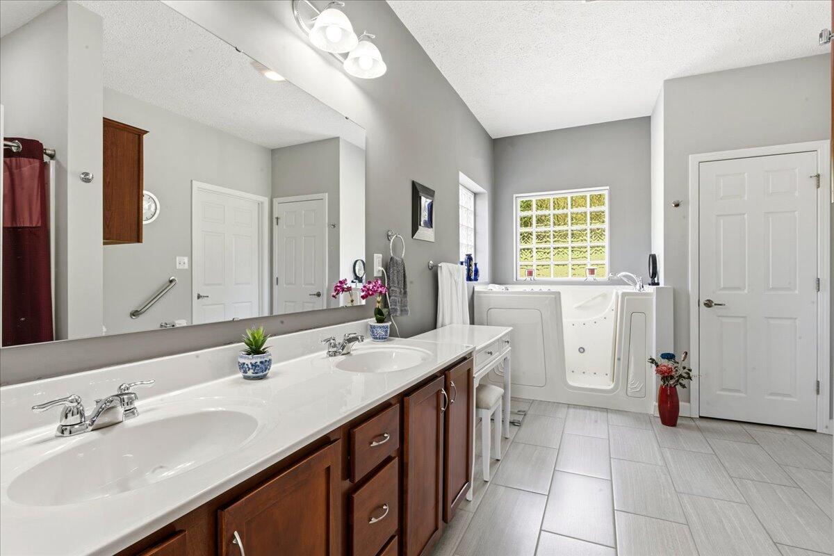 218 Mt Moriah Road Eagle Rock, VA 24085 - Photo 19 of 38 a bathroom with a sink double vanity granite tub and a mirror