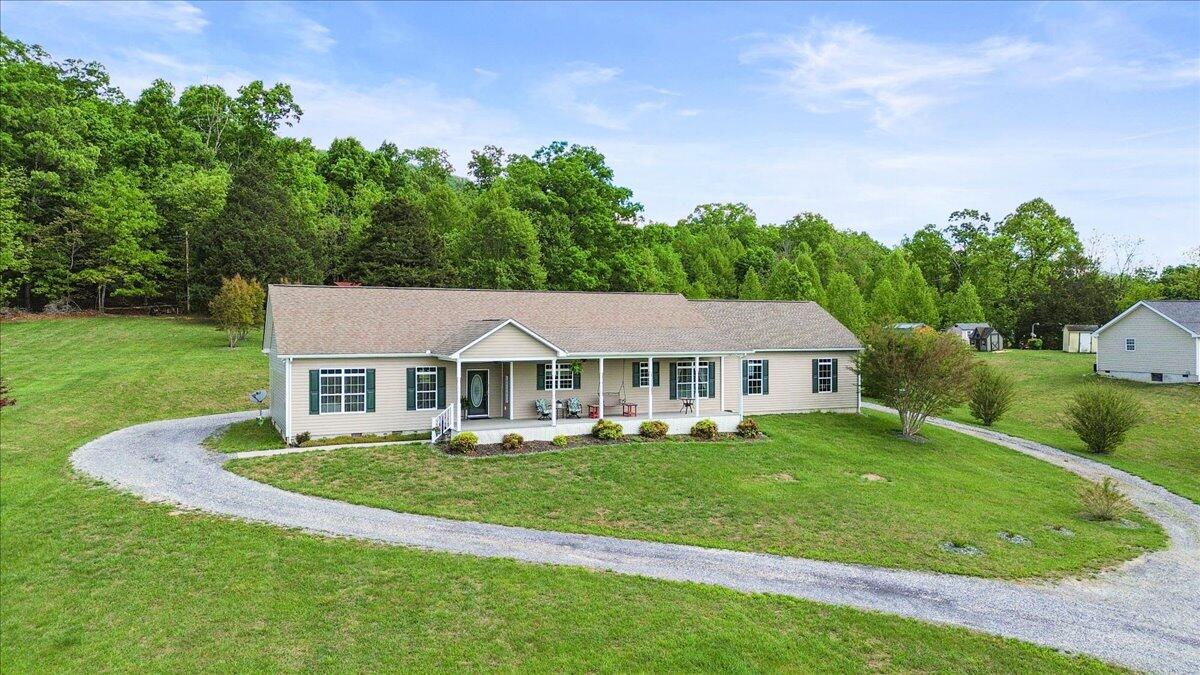 218 Mt Moriah Road Eagle Rock, VA 24085 - Photo 4 of 38 a front view of a house with a yard table and chairs