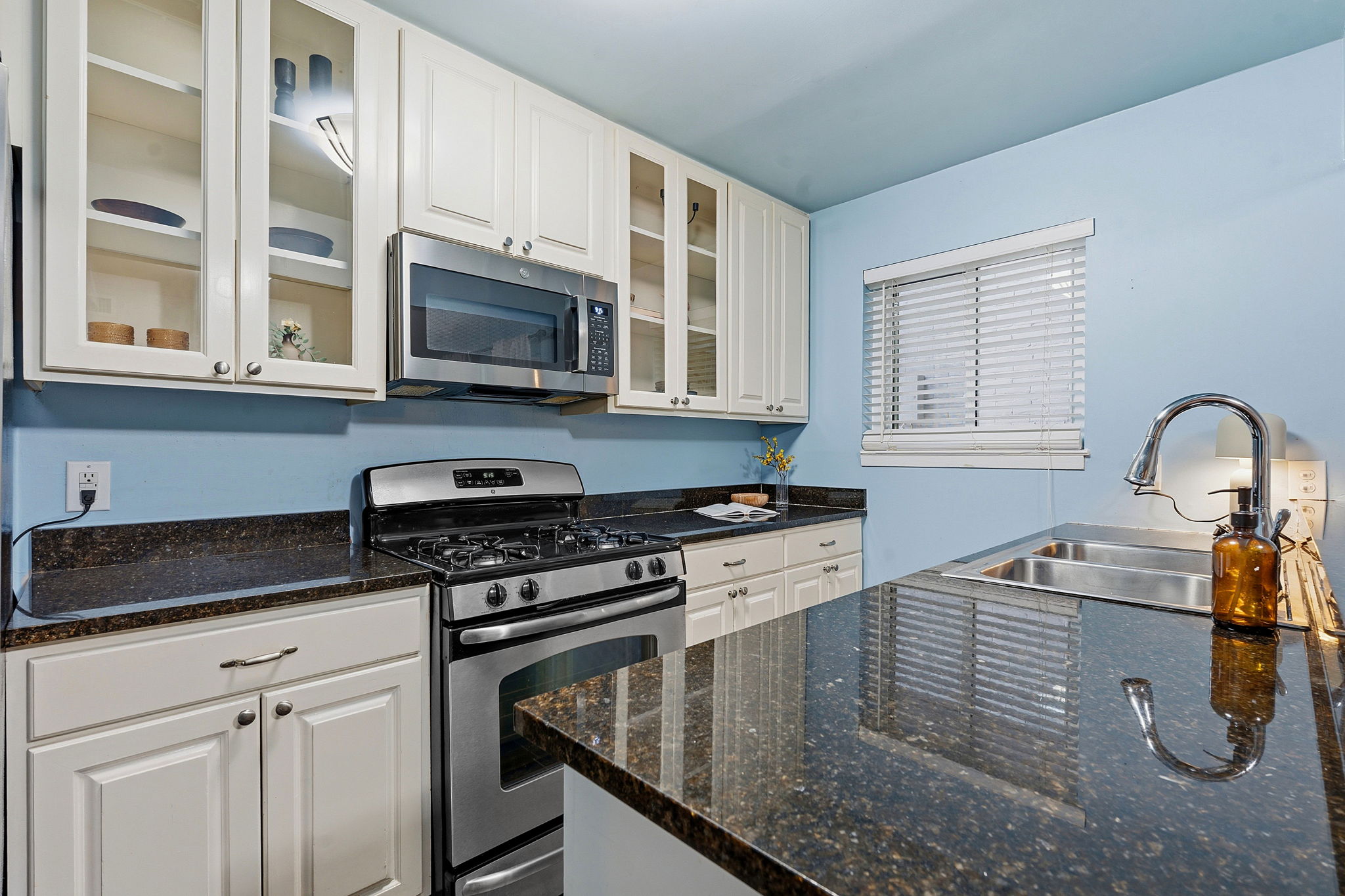 1210 Windsor Road, Unit 104 Austin, TX 78703 - Photo 6 of 29 Culinary delights await in this compact kitchen with generous counter space and stainless steel appliances.