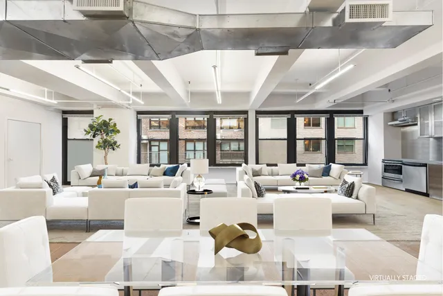 a living room with furniture large windows and a table