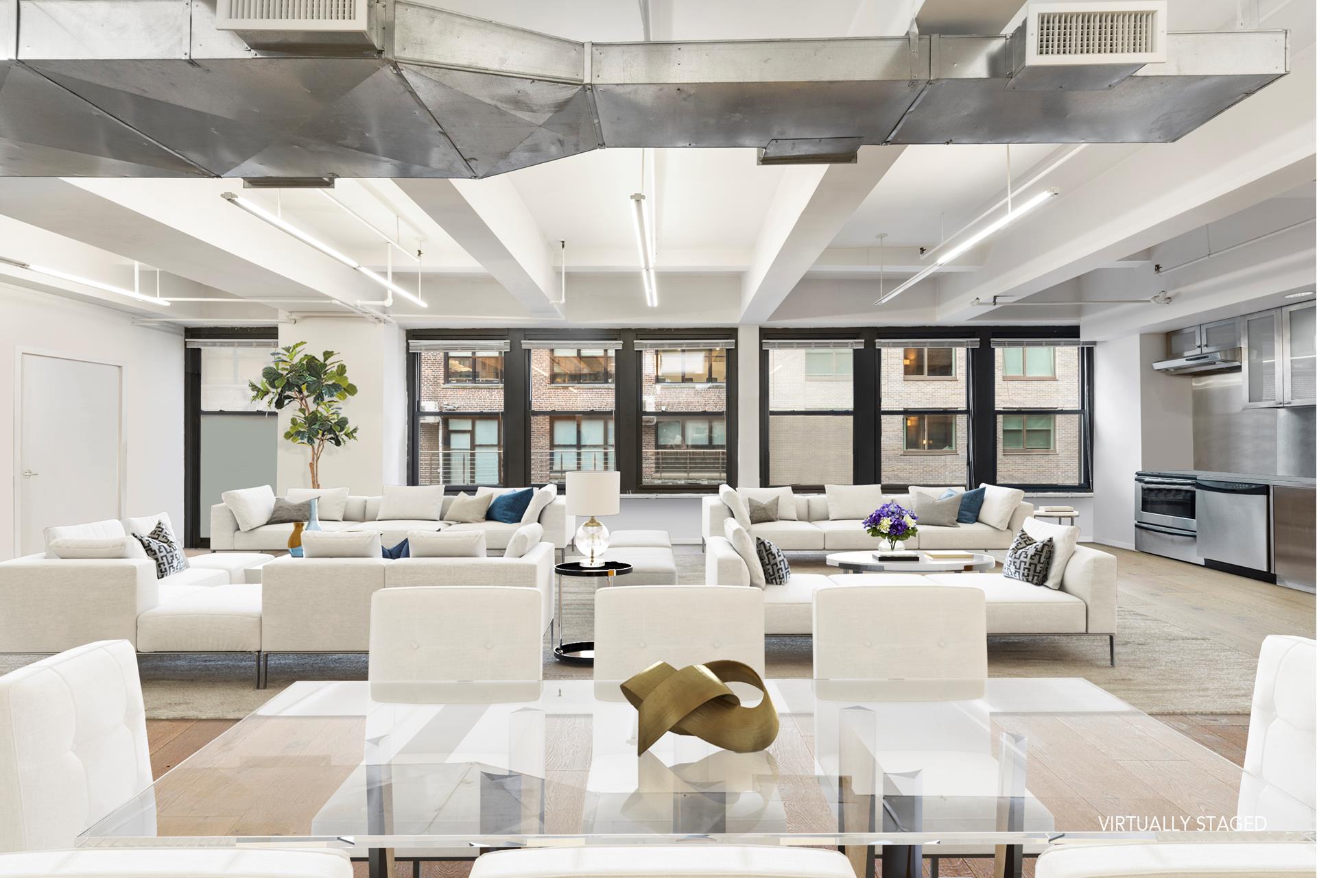 315 West 36th Street, Unit 12B Manhattan, NY 10018 - Photo 1 of 33 a living room with furniture large windows and a table