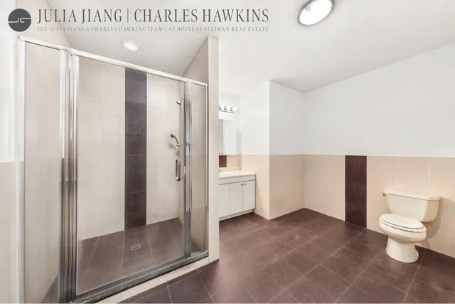 a bathroom with a toilet and a shower