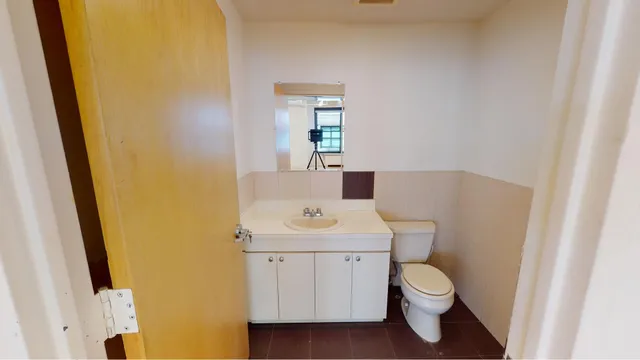 a bathroom with a sink a toilet and a mirror
