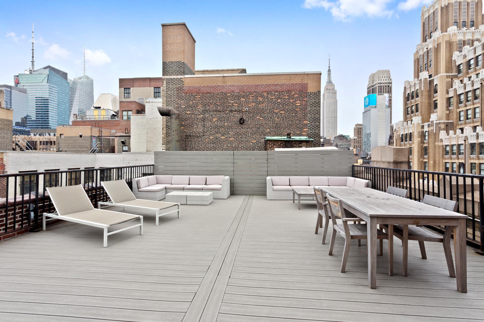 315 West 36th Street, Unit 12B Manhattan, NY 10018 - Photo 11 of 33 a balcony with wooden floor table and chairs