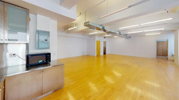 a view of an empty room with a fireplace