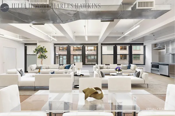 a living room with furniture large windows and a rug