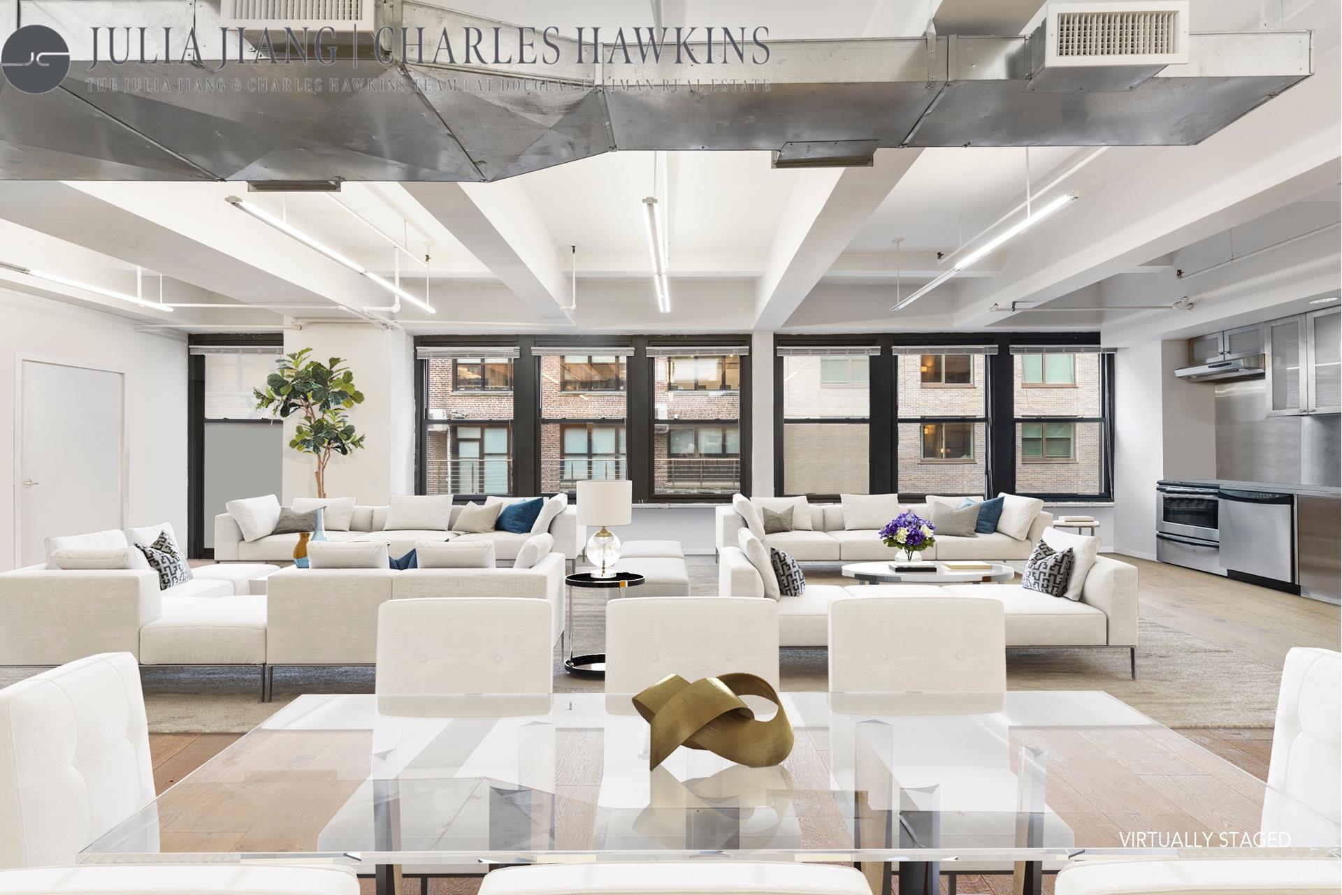 315 West 36th Street, Unit 12B Manhattan, NY 10018 - Photo 20 of 33 a living room with furniture large windows and a rug