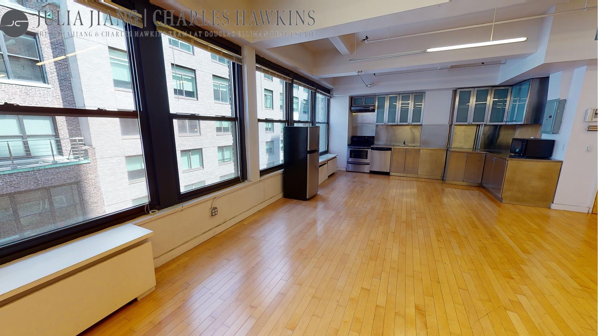 315 West 36th Street, Unit 12B Manhattan, NY 10018 - Photo 25 of 33 a living room with furniture and large windows