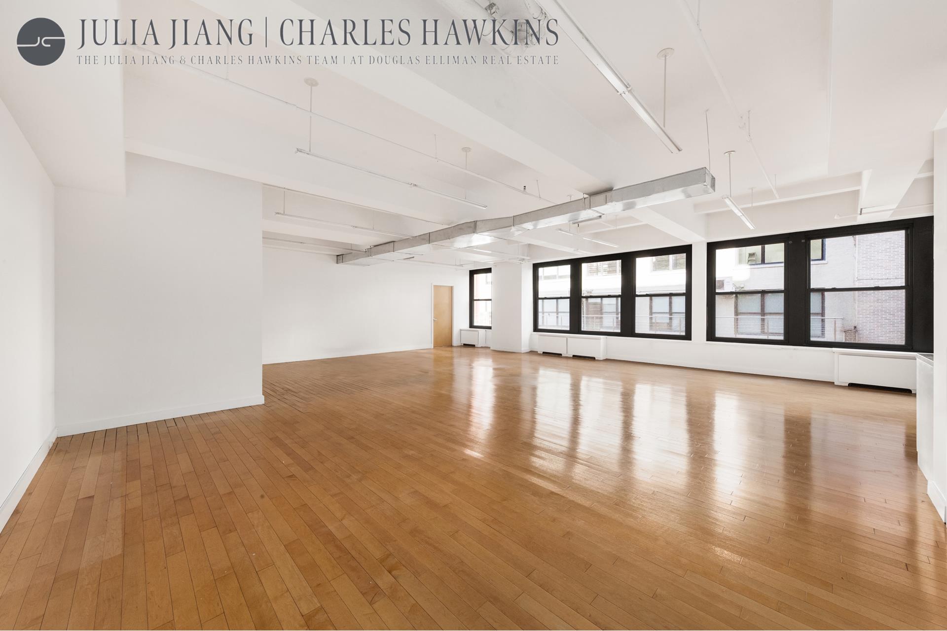 315 West 36th Street, Unit 12B Manhattan, NY 10018 - Photo 2 of 33 a view of an empty room with wooden floor and a window