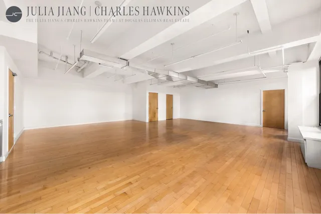 en empty room with windows and ceiling fan