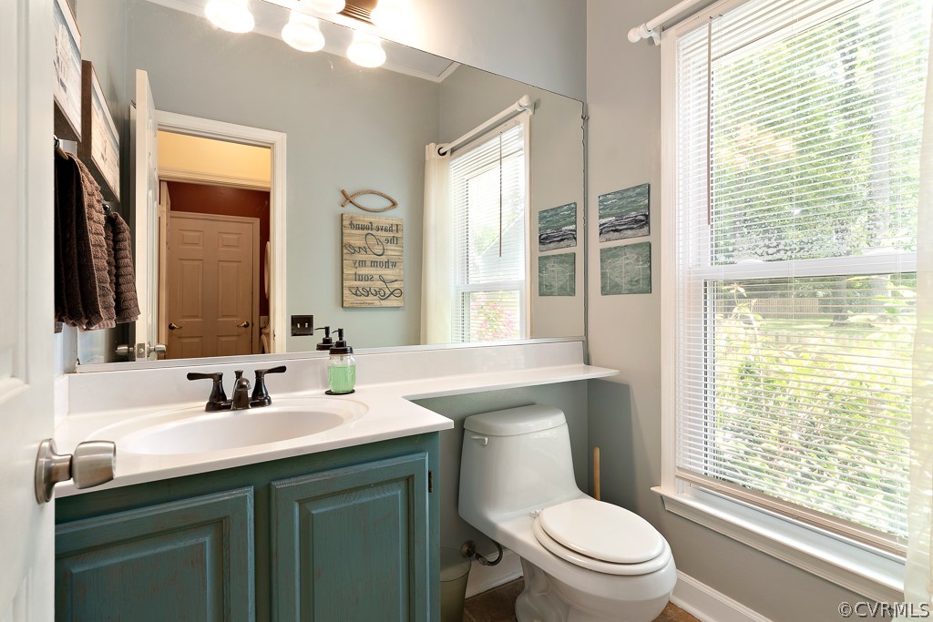 13903 Eastbluff Road Midlothian, VA 23112 - Photo 21 of 45 a bathroom with a toilet a sink a mirror a window and vanity