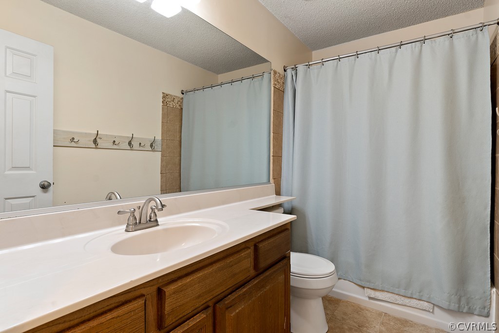 13903 Eastbluff Road Midlothian, VA 23112 - Photo 28 of 45 a bathroom with a sink a toilet a mirror and shower curtain