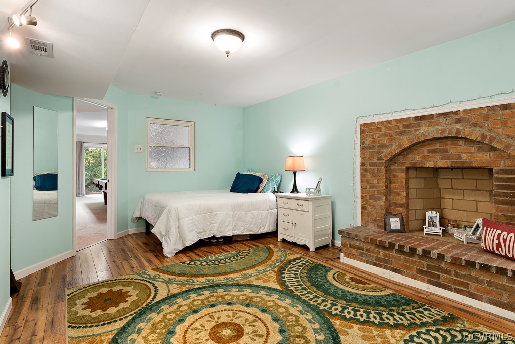 13903 Eastbluff Road Midlothian, VA 23112 - Photo 38 of 45 a bedroom with furniture and a fireplace