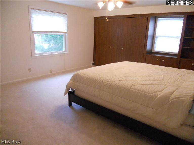 1945 Temblethurst Road South Euclid, OH 44121 - Photo 8 of 15 Master Bedroom with Walk-in Closet, Double Closet and Wall Unit with a 2nd Double Closet with Organizer System, Built-in Book Shelves and Cabinets, Jack-n-Jill Full Bath and Newer Carpeting