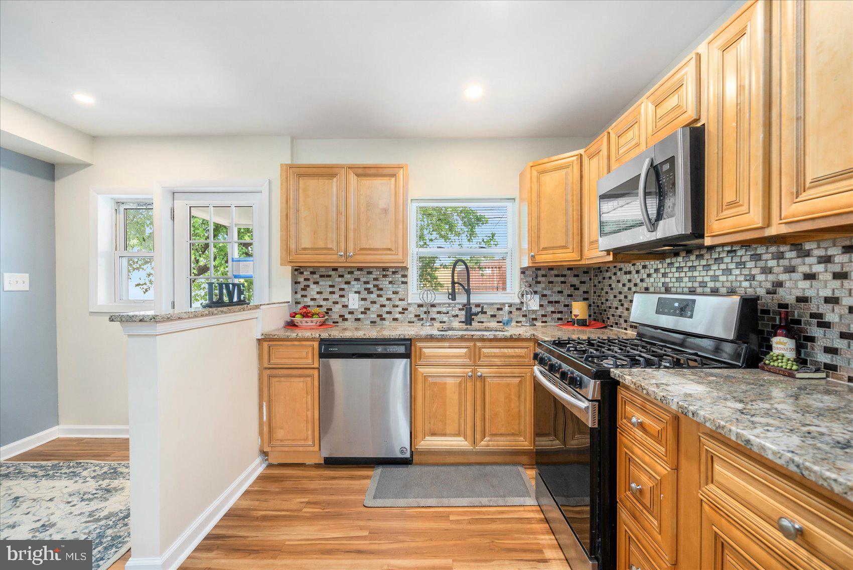 7932 Kavanagh Road Dundalk, MD 21222 - Photo 11 of 39 a kitchen with stainless steel appliances granite countertop a stove a sink and a microwave