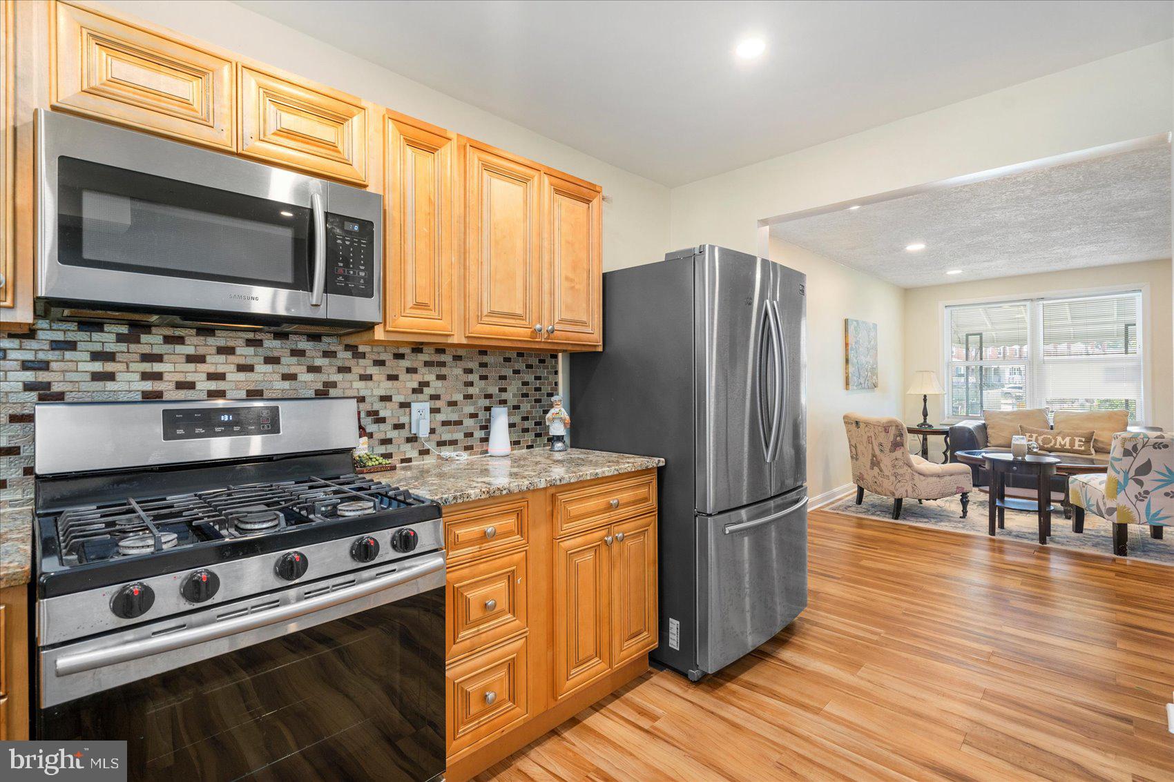 7932 Kavanagh Road Dundalk, MD 21222 - Photo 14 of 39 a kitchen with wooden cabinets and stainless steel appliances