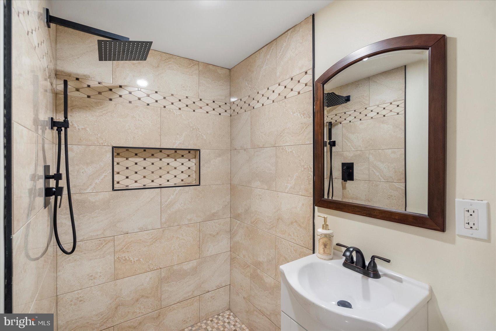 7932 Kavanagh Road Dundalk, MD 21222 - Photo 24 of 39 a bathroom with a shower sink and mirror