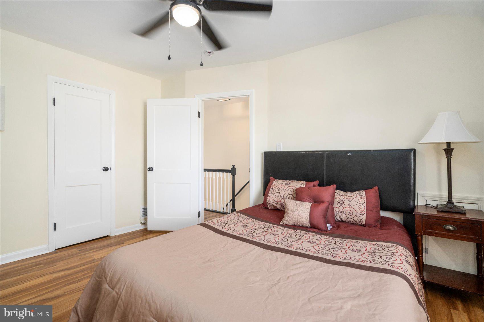 7932 Kavanagh Road Dundalk, MD 21222 - Photo 32 of 39 a bedroom with a bed and a lamp