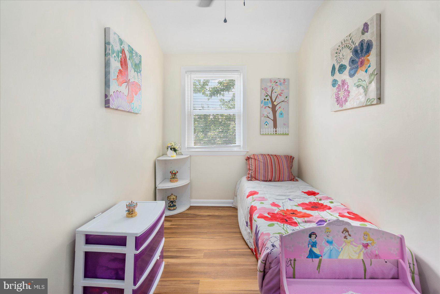 7932 Kavanagh Road Dundalk, MD 21222 - Photo 35 of 39 a bedroom with a bed and wooden floor