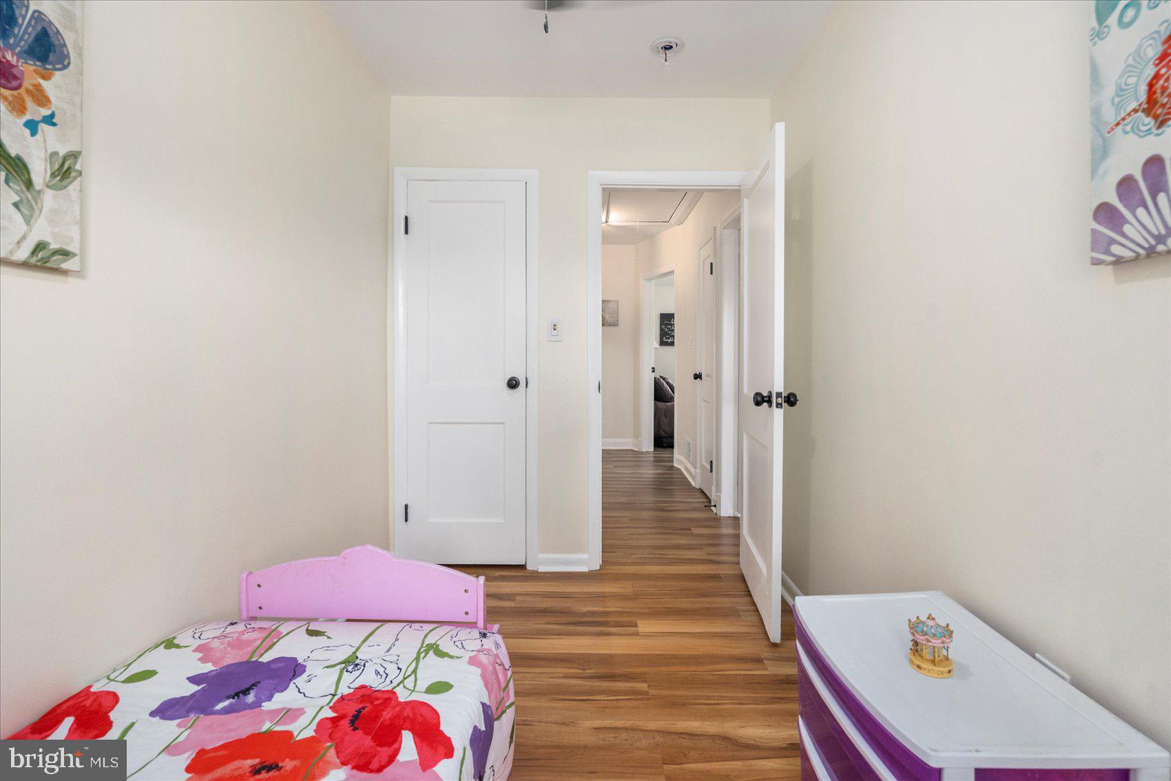 7932 Kavanagh Road Dundalk, MD 21222 - Photo 36 of 39 a bedroom with a bed and wooden floor